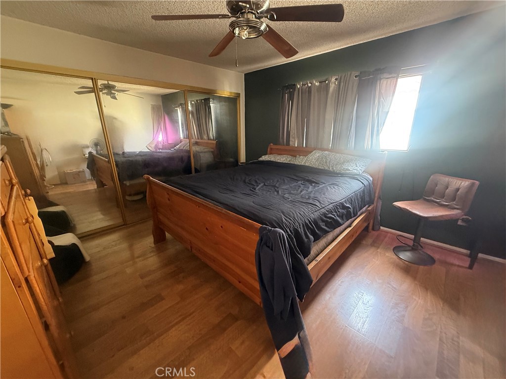 8634 Park, Unit 3 Bellflower, CA 90706 - Photo 9 of 12 a bed room with a bed and a chandelier
