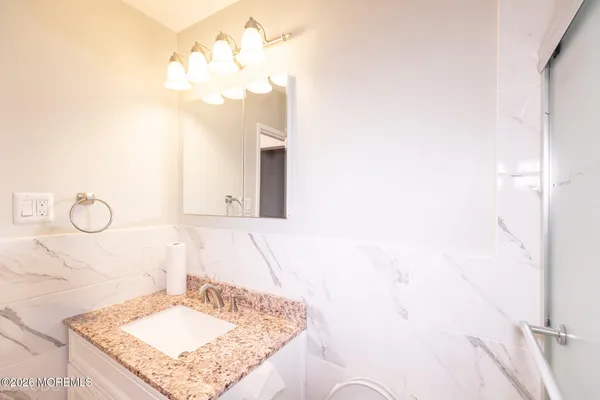 a bathroom with a sink vanity and a mirror