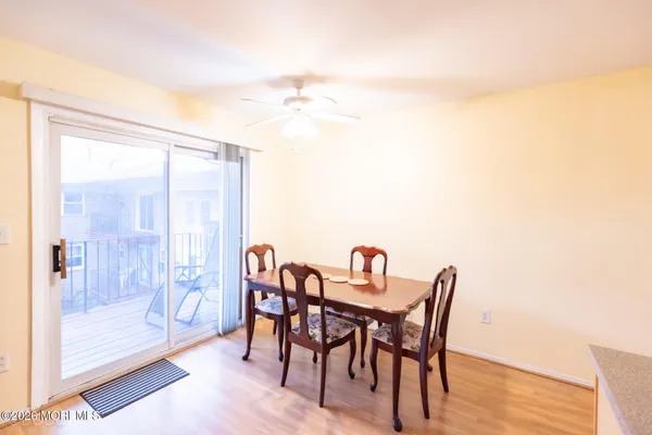 a dining room with furniture and wooden floor