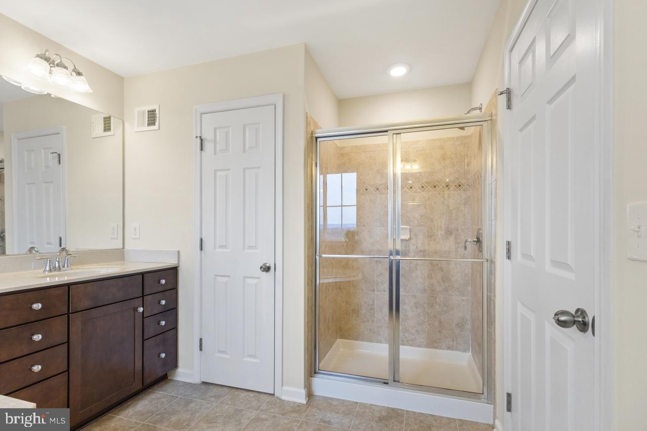 43367 Town Gate Square Chantilly, VA 20152 - Photo 19 of 36 a bathroom with a shower sink and mirror