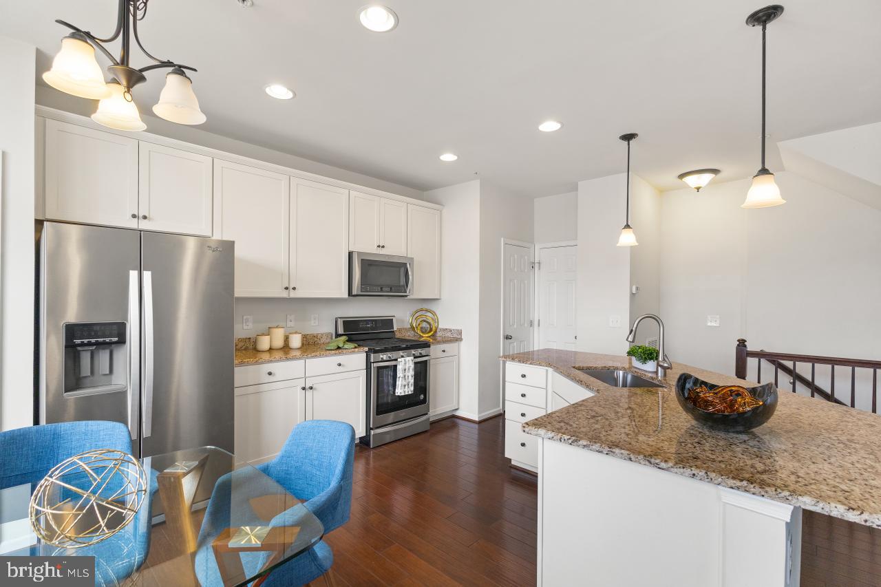 43367 Town Gate Square Chantilly, VA 20152 - Photo 7 of 36 a kitchen with granite countertop kitchen island stainless steel appliances a stove a sink a refrigerator and cabinets