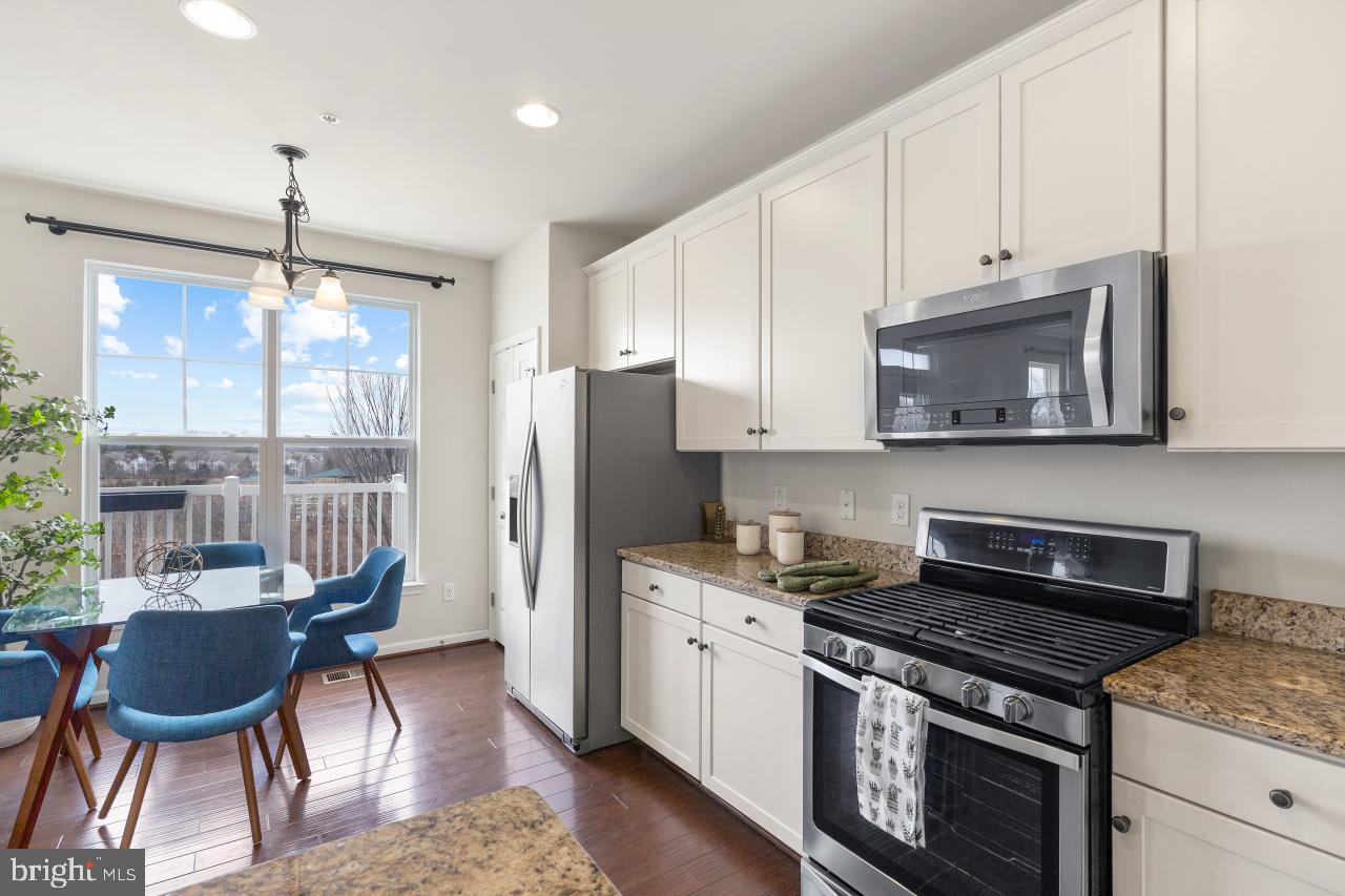 43367 Town Gate Square Chantilly, VA 20152 - Photo 9 of 36 a kitchen with stainless steel appliances granite countertop a stove a refrigerator and a microwave
