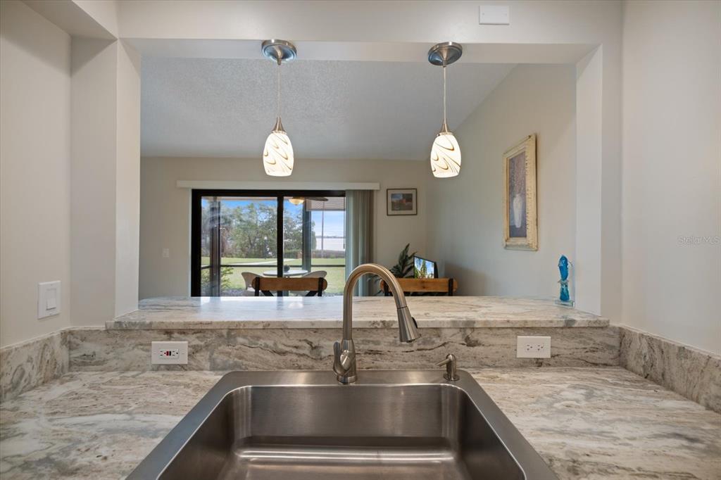 1610 Stickney Point Road, Unit 16101 Sarasota, FL 34231 - Photo 10 of 21 a kitchen with a sink and a window