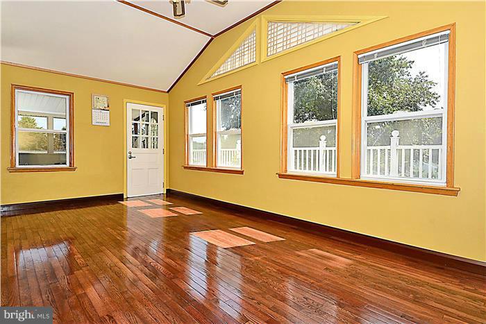 6716 Garrett Road Derwood, MD 20855 - Photo 11 of 30 a view of an empty room with wooden floor and a window