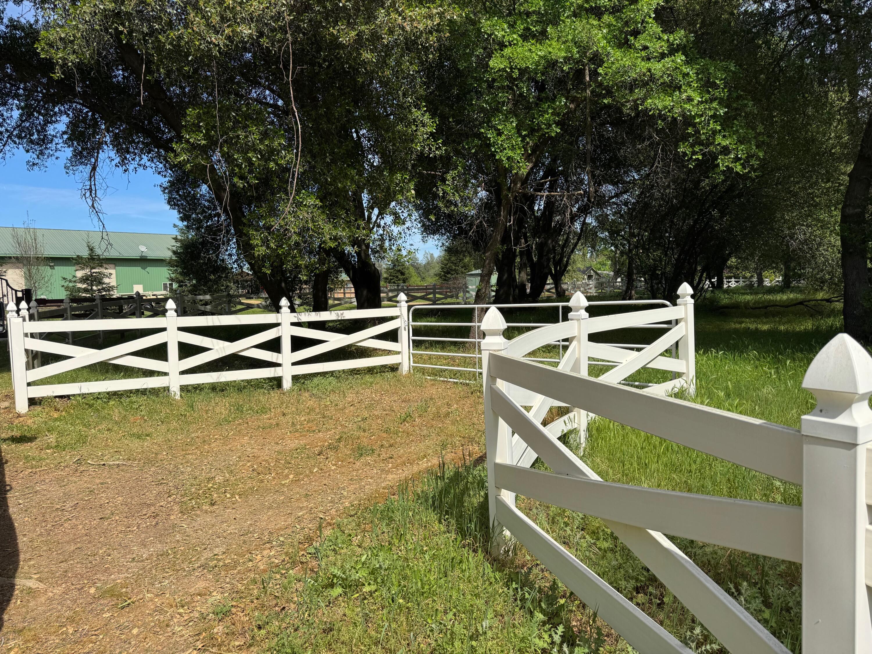 Clough Creek Road Redding, CA 96002 - Photo 5 of 23 a view of a house with a wooden deck and trees