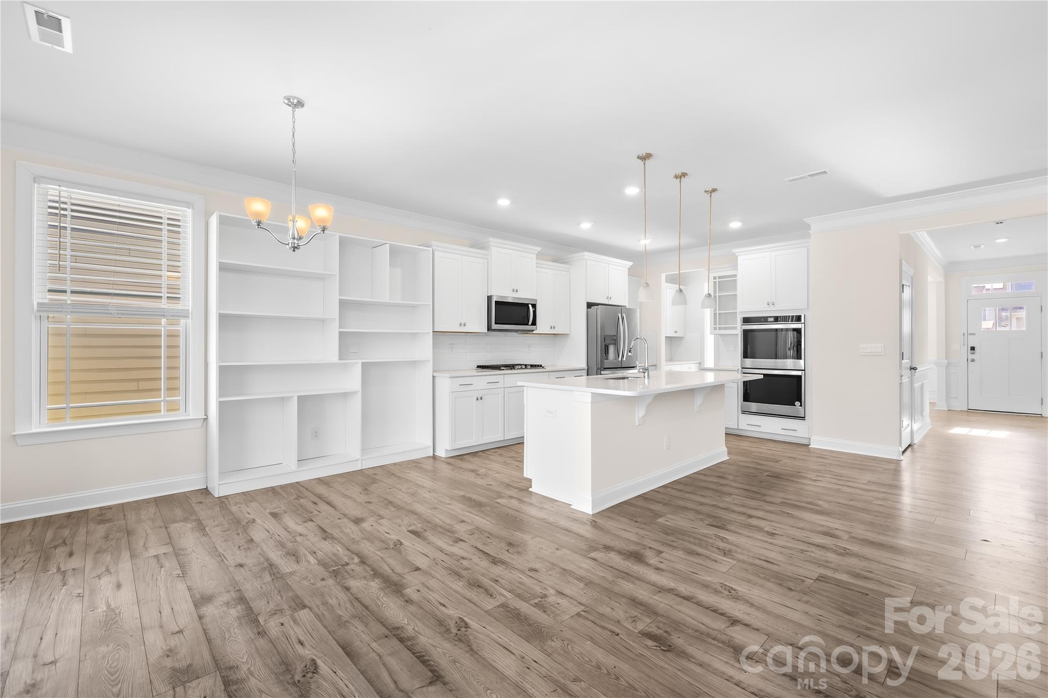402 Preston Road Mooresville, NC 28117 - Photo 12 of 42 a view of kitchen with wooden floor and window