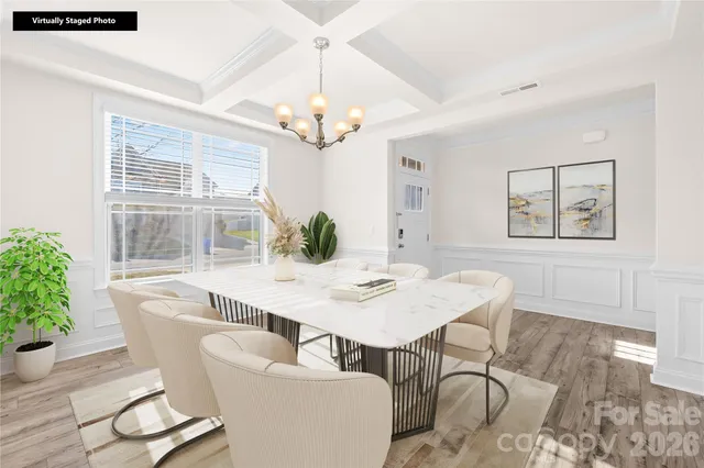a view of a dining room with furniture wooden floor and chandelier
