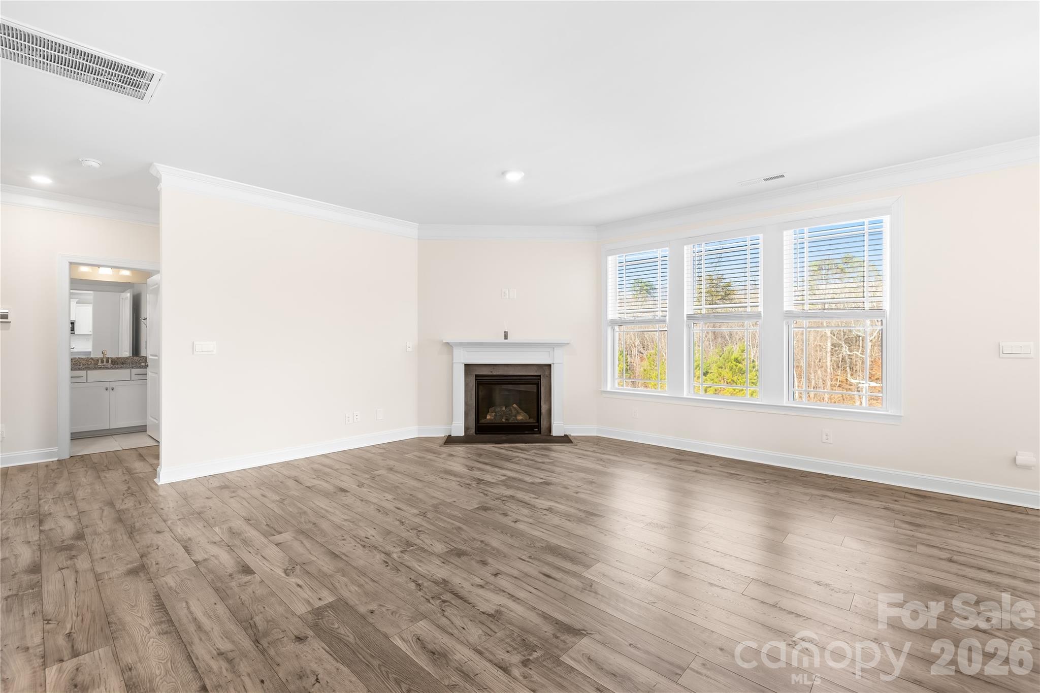 402 Preston Road Mooresville, NC 28117 - Photo 8 of 42 an empty room with windows and fireplace