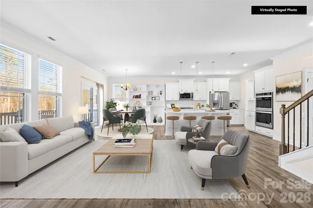 a living room with furniture and kitchen view