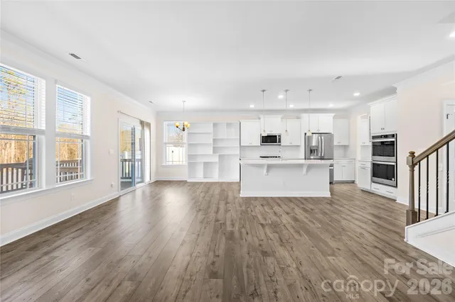 a view of kitchen with wooden floor and windows