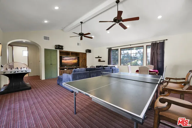 a view of a living room and dining room with wooden floor