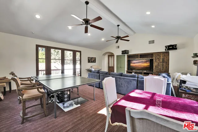 a dining room with furniture a chandelier and wooden floor