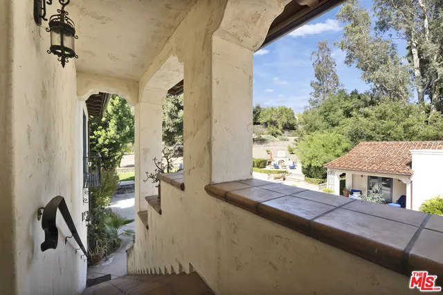 a balcony view with a potted plant