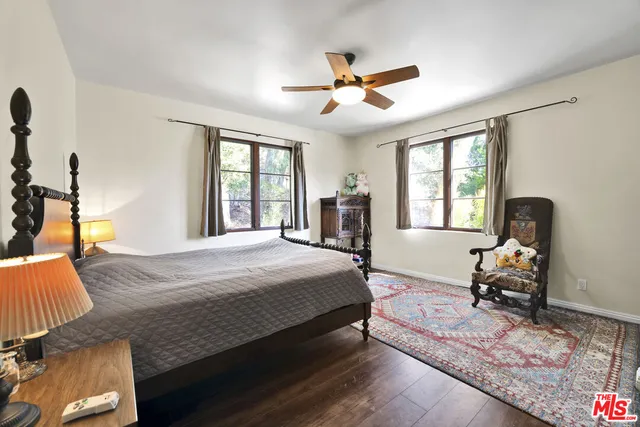 a bedroom with a bed couch and a window