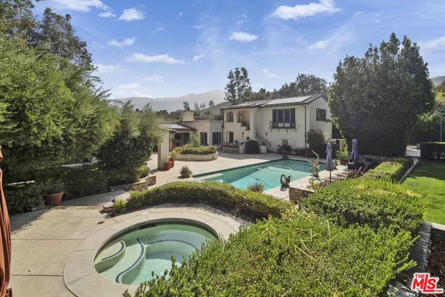 a swimming pool with outdoor seating and yard