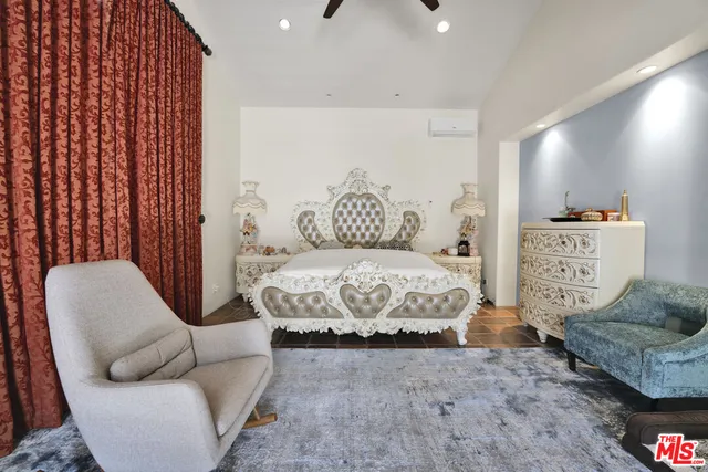 a bedroom with a bed and couch