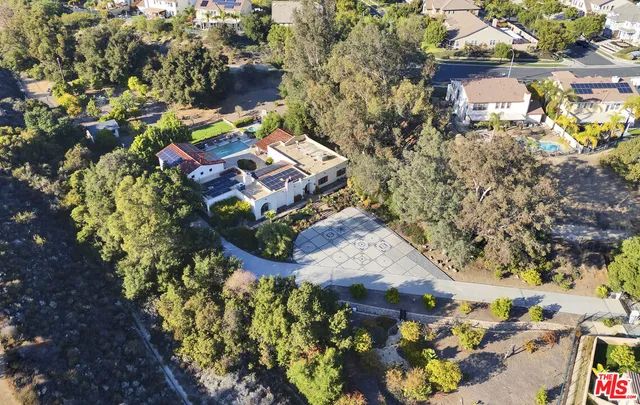 an aerial view of a house with a yard and garden