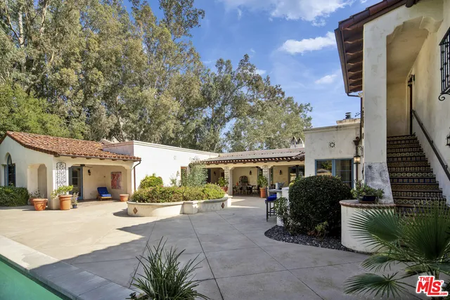 a building outdoor space with patio furniture and potted plants