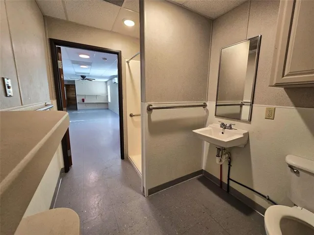 a bathroom with sink a mirror a toilet and a mirror