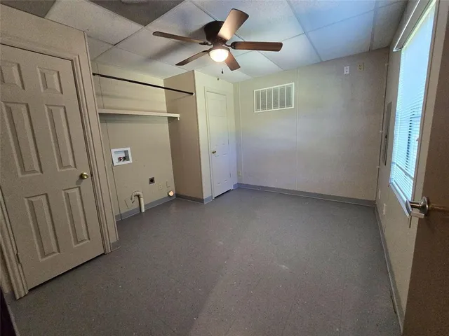 a view of a room with a ceiling fan