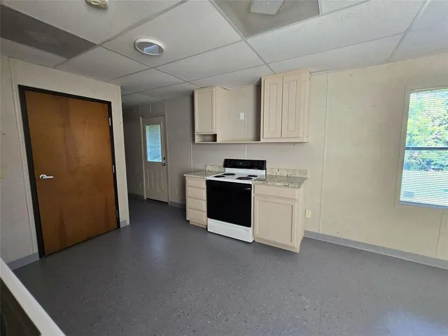 a kitchen with stainless steel appliances a stove a microwave and a refrigerator