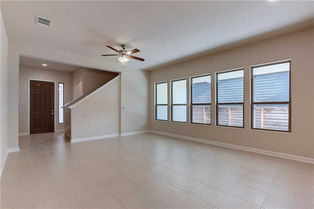 6907 Idea Road Austin, TX 78741 - Photo 5 of 29 Living area with light tiled flooring and lots of windows letting in ample lighting