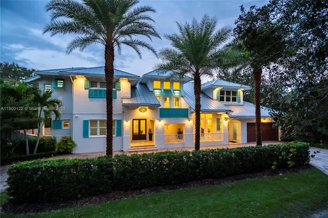 a front view of multiple houses with yard
