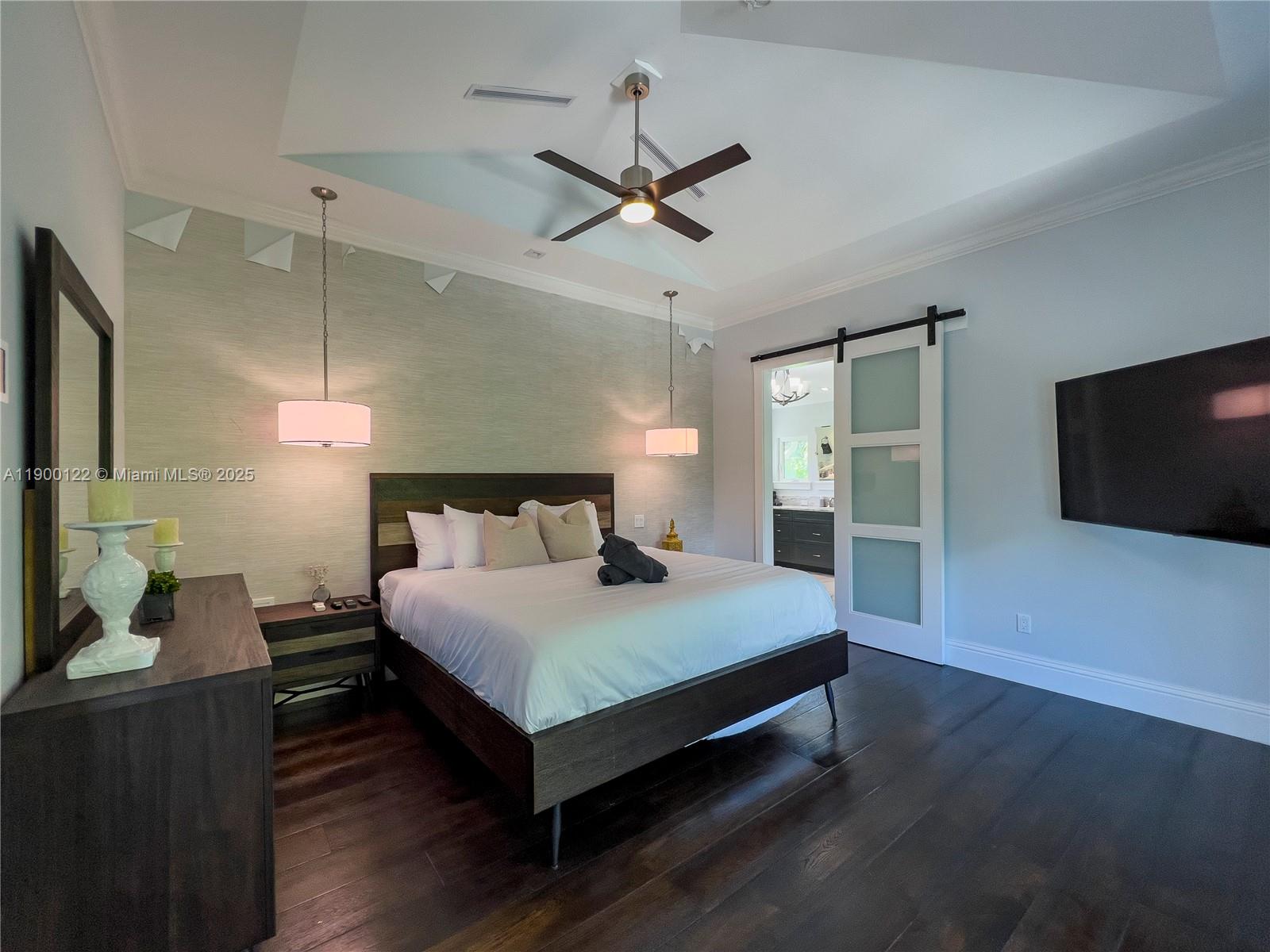 545 Southwest Indianola Street Stuart, FL 34994 - Photo 34 of 64 a bedroom with a bed and a flat screen tv