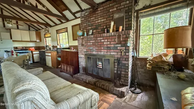 a view of a dining room with furniture a chandelier and wooden floor