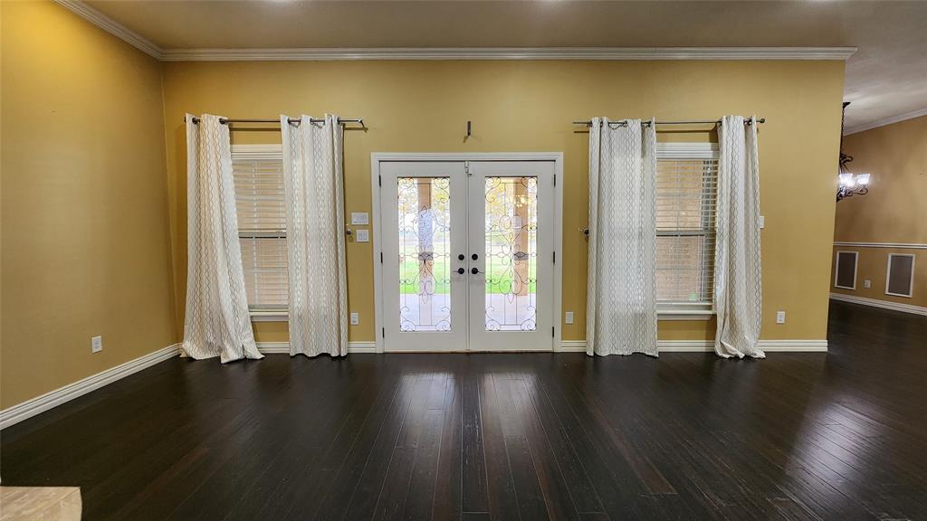 511 East Cook Street, Unit 1 Josephine, TX 75173 - Photo 12 of 36 an empty room with wooden floor and windows