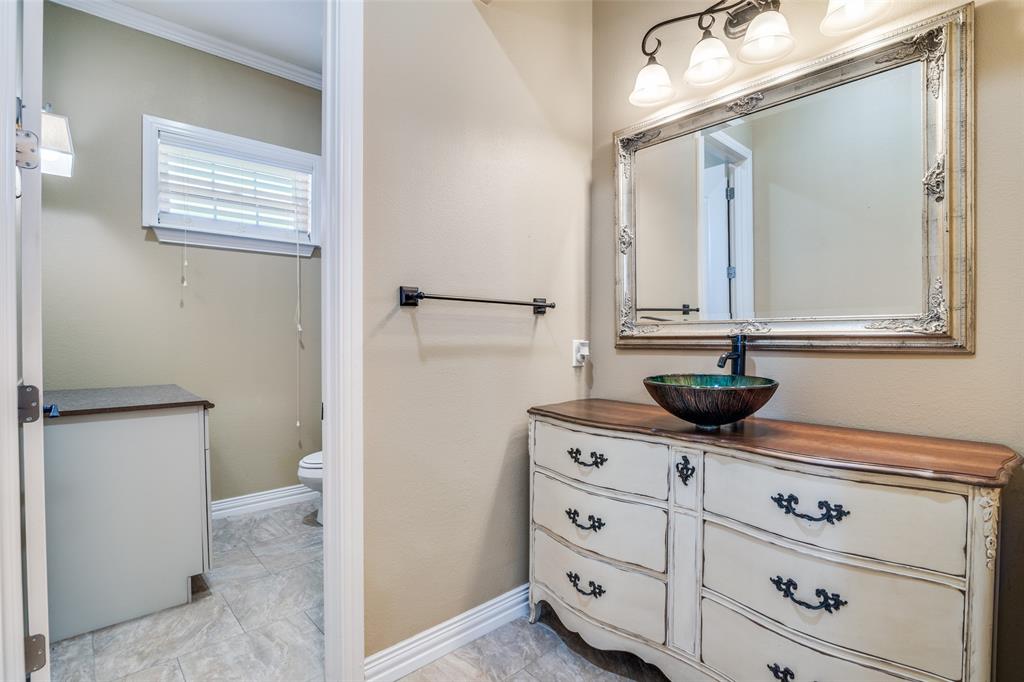 511 East Cook Street, Unit 1 Josephine, TX 75173 - Photo 17 of 29 a bathroom with a toilet sink and mirror