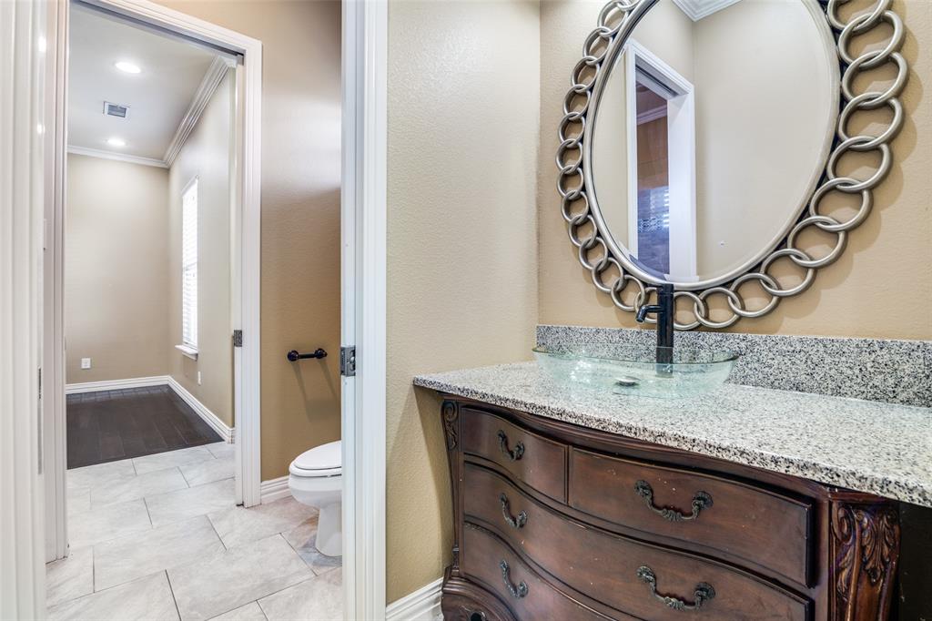 511 East Cook Street, Unit 1 Josephine, TX 75173 - Photo 25 of 29 a bathroom with a granite countertop sink mirror and vanity