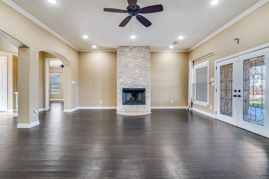 511 East Cook Street, Unit 1 Josephine, TX 75173 - Photo 6 of 29 an empty room with wooden floor a ceiling fan and windows