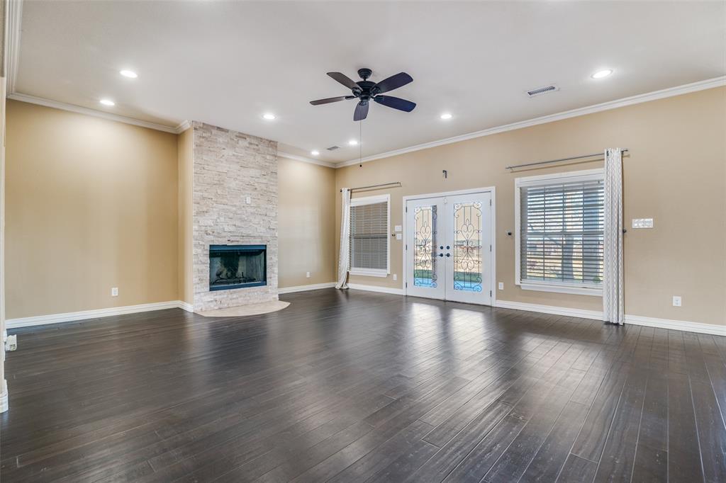 511 East Cook Street, Unit 1 Josephine, TX 75173 - Photo 7 of 29 an empty room with wooden floor fireplace and windows