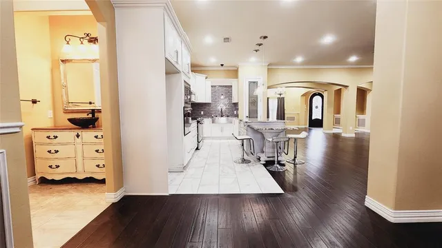 a large kitchen with a table and chairs