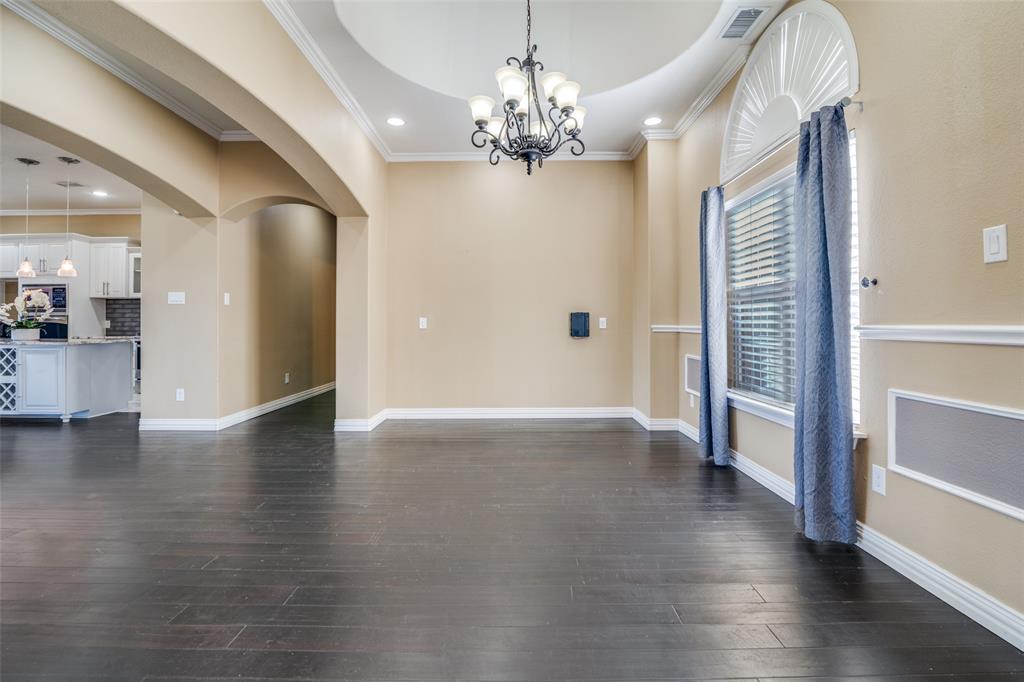 511 East Cook Street, Unit 1 Josephine, TX 75173 - Photo 9 of 29 a view of a hallway with wooden floor and a chandelier