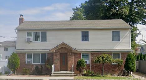 133 Railroad Avenue, Unit 2 Syosset, NY 11791 - Photo 11 of 11 a front view of a house with a yard