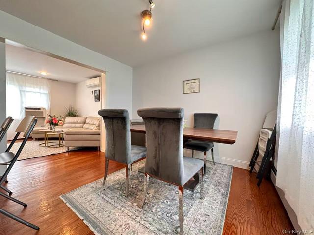 133 Railroad Avenue, Unit 2 Syosset, NY 11791 - Photo 2 of 11 a living room with furniture and a wooden floor