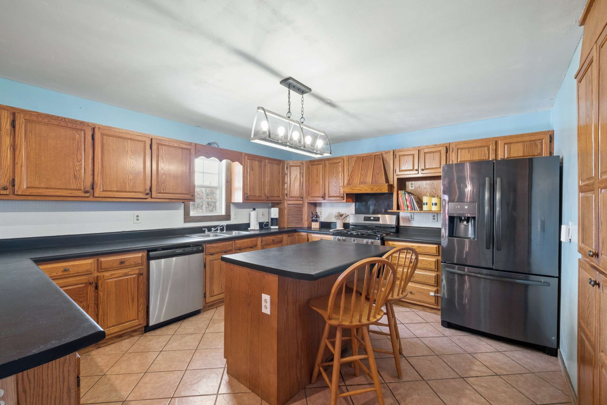 324 Laster-Holman Lane Decherd, TN 37324 - Photo 12 of 60 a kitchen with stainless steel appliances granite countertop a sink a stove a refrigerator cabinets and a dining table