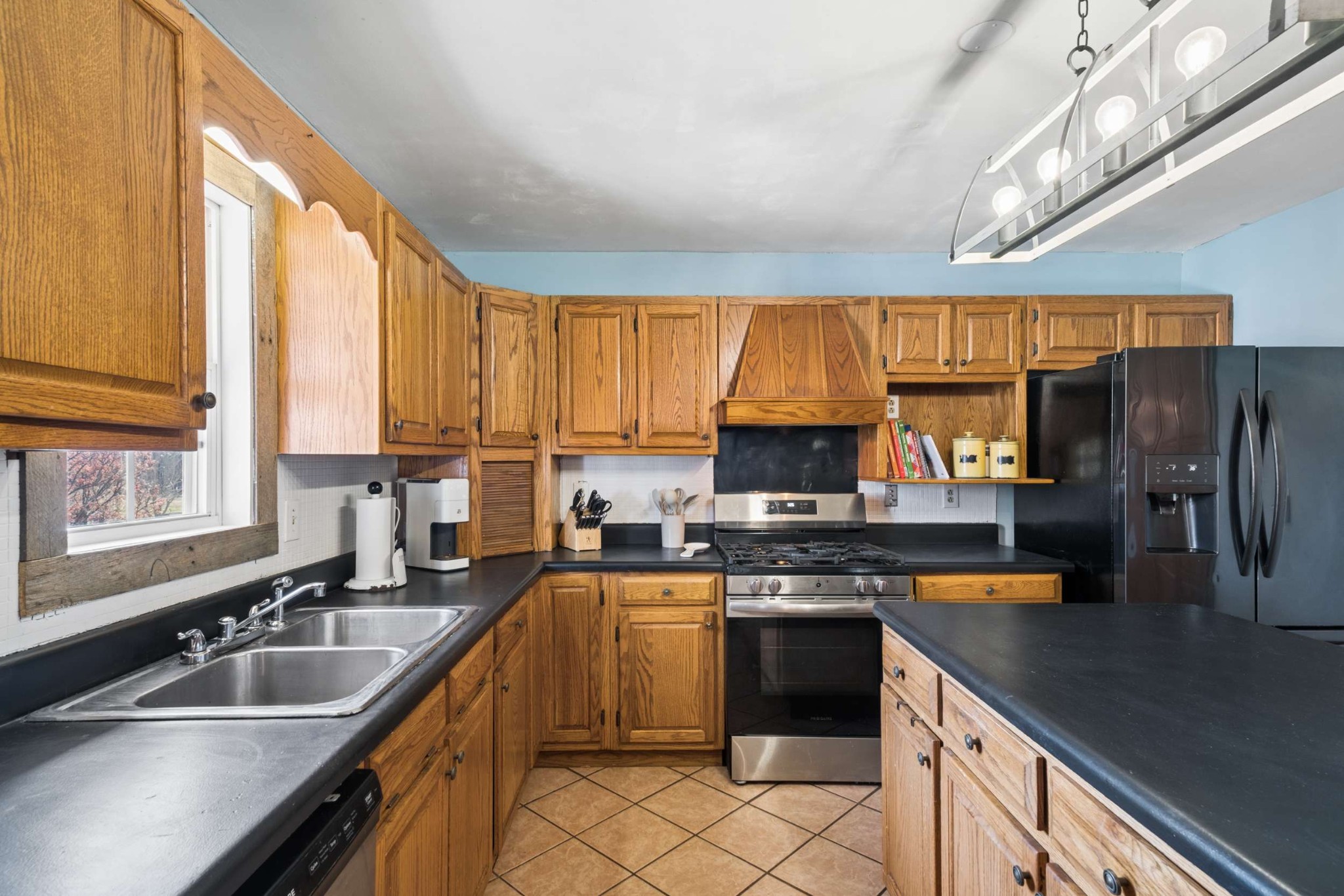 324 Laster-Holman Lane Decherd, TN 37324 - Photo 13 of 60 a kitchen with stainless steel appliances a sink dishwasher a stove top oven a refrigerator with grey cabinets and wooden floor