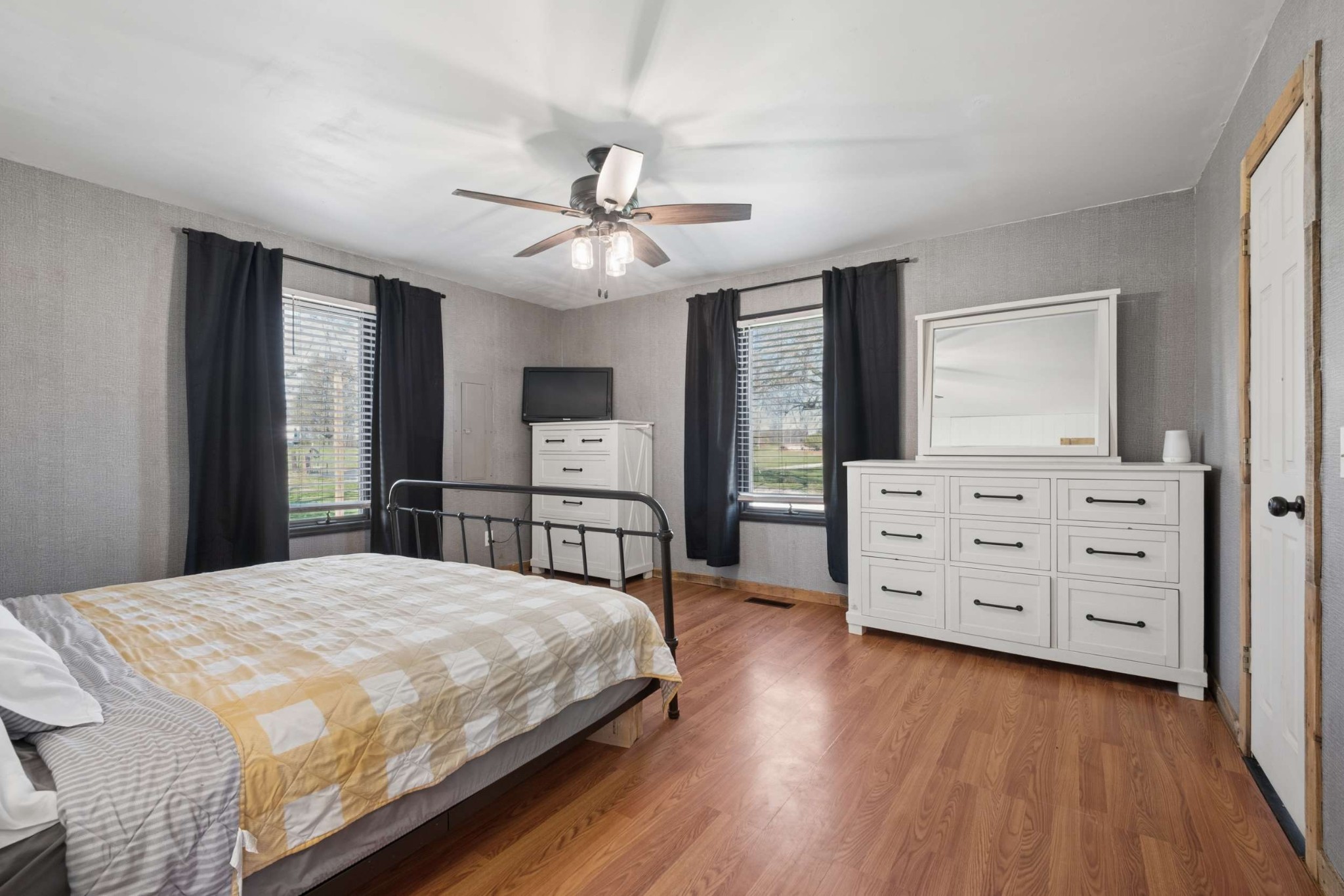 324 Laster-Holman Lane Decherd, TN 37324 - Photo 18 of 60 a bedroom with a bed a dresser and a large mirror