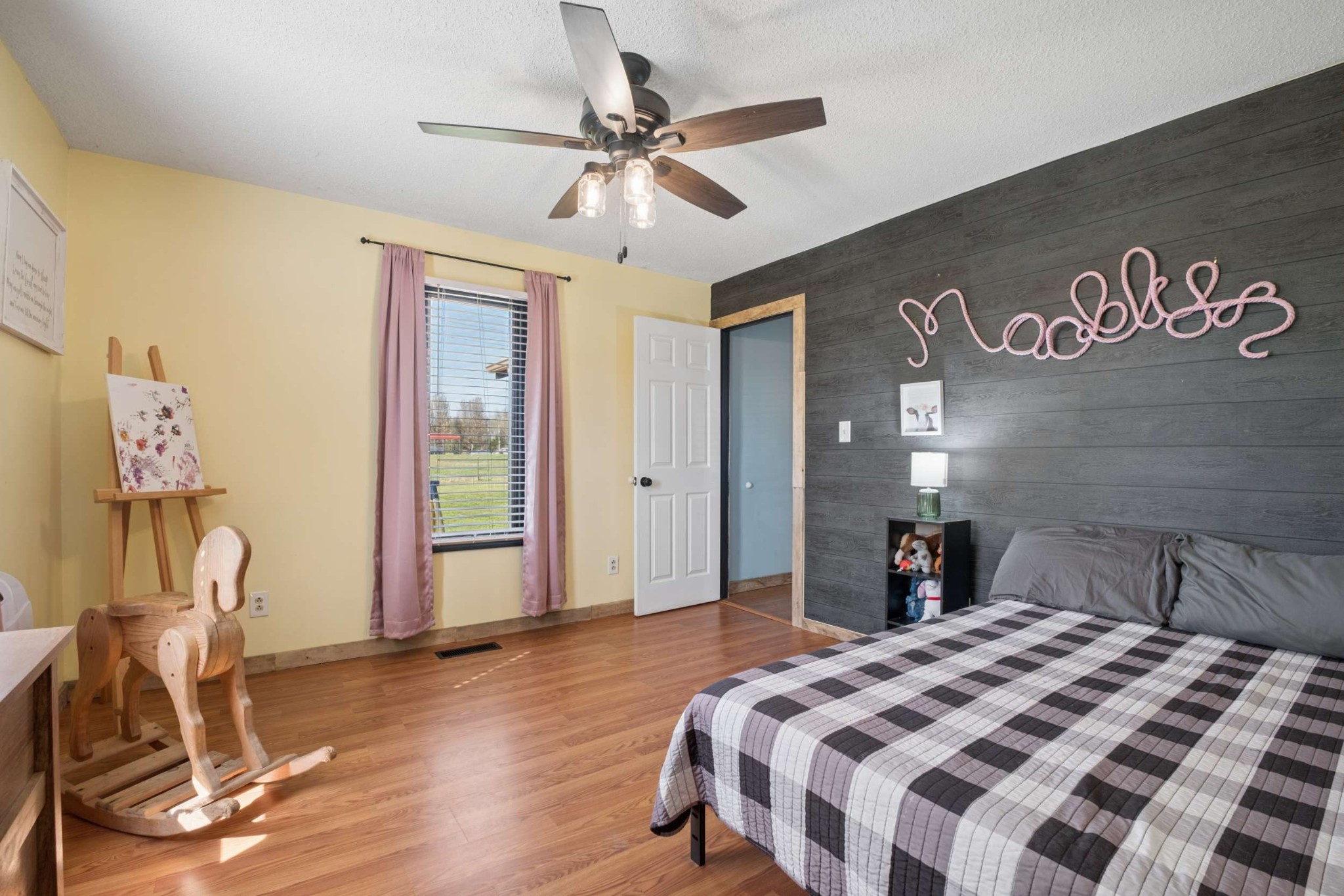 324 Laster-Holman Lane Decherd, TN 37324 - Photo 22 of 60 a bedroom with a bed and a chandelier