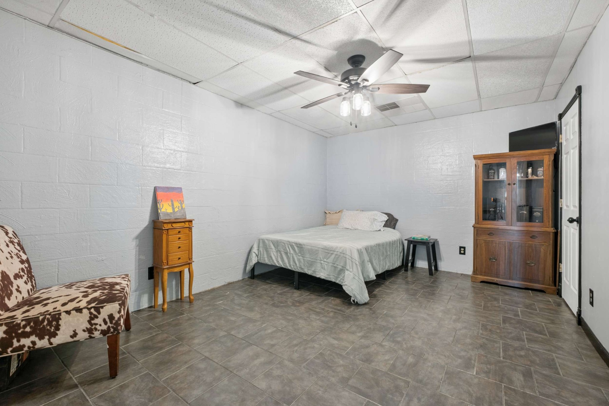324 Laster-Holman Lane Decherd, TN 37324 - Photo 29 of 60 a spacious bedroom with a bed and a chandelier
