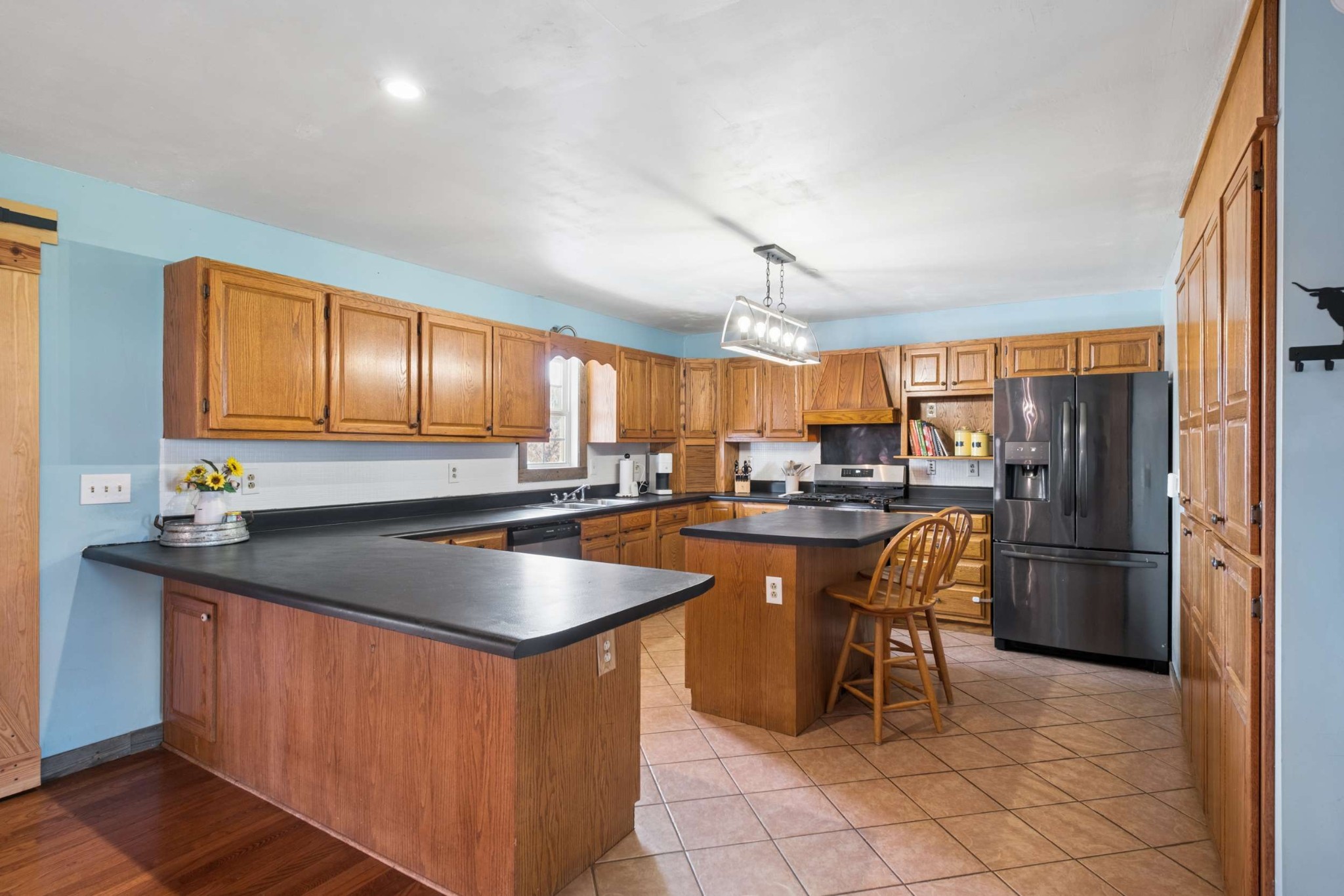 324 Laster-Holman Lane Decherd, TN 37324 - Photo 10 of 60 a kitchen with stainless steel appliances granite countertop a sink a counter and chairs