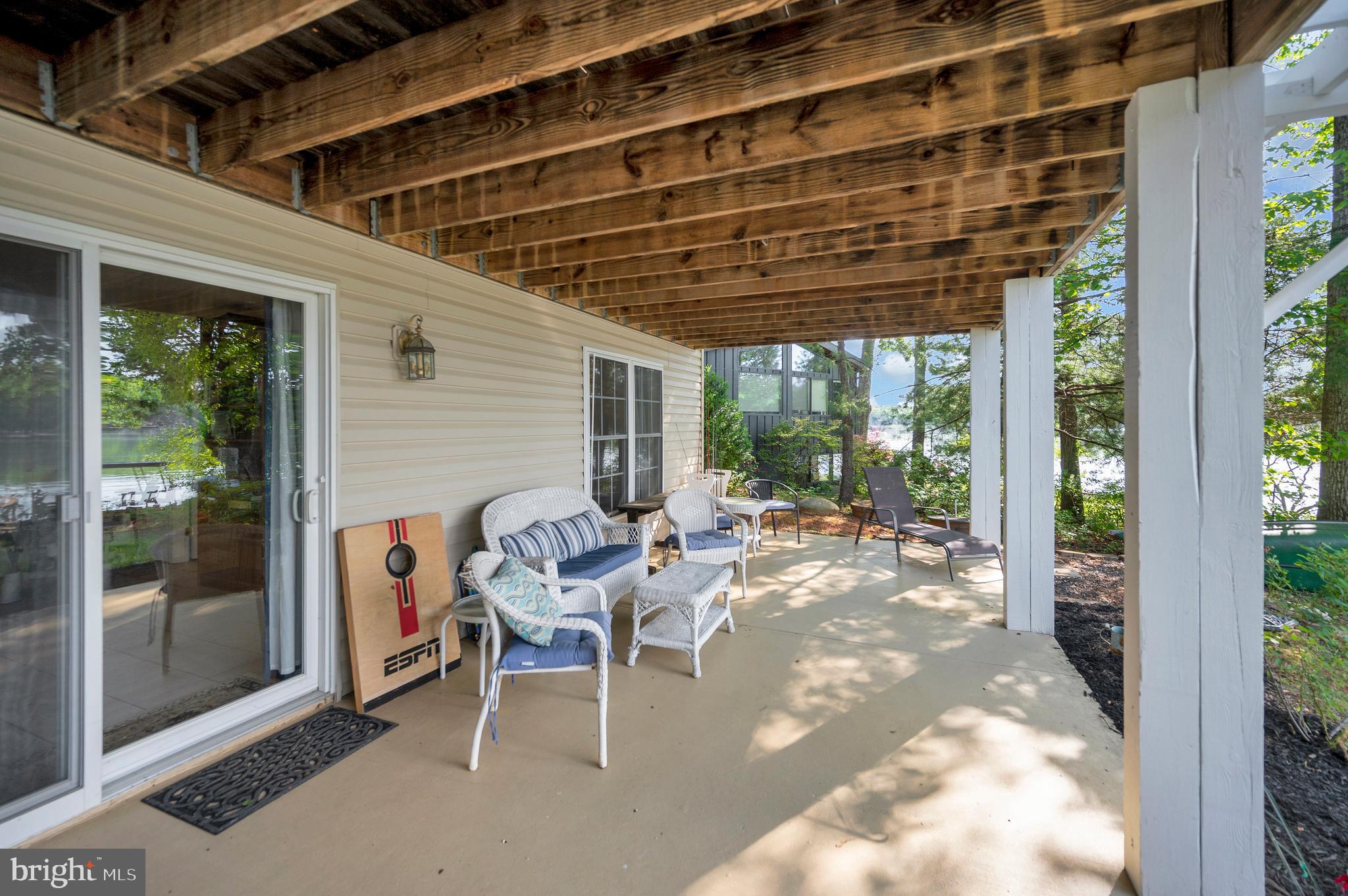 626 Cornwallis Avenue Locust Grove, VA 22508 - Photo 53 of 85 a view of a patio with a table and chairs and floor to ceiling window