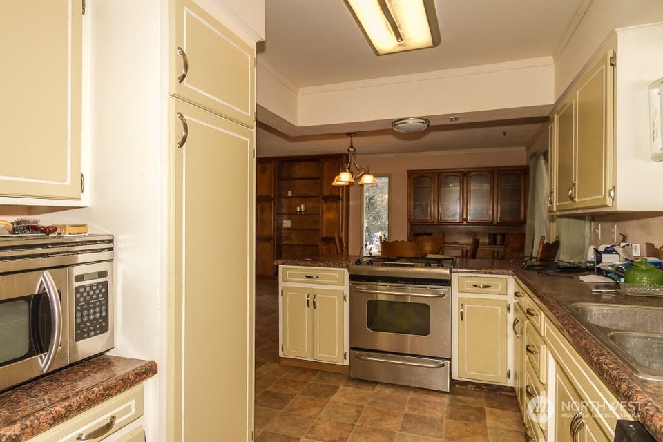 1144 State Rte 20 Colville, WA 99114 - Photo 12 of 38 a kitchen with a stove oven and sink