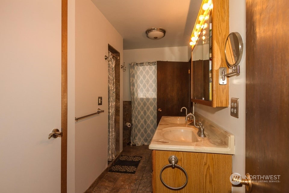 1144 State Rte 20 Colville, WA 99114 - Photo 13 of 38 a bathroom with a granite countertop sink and a mirror