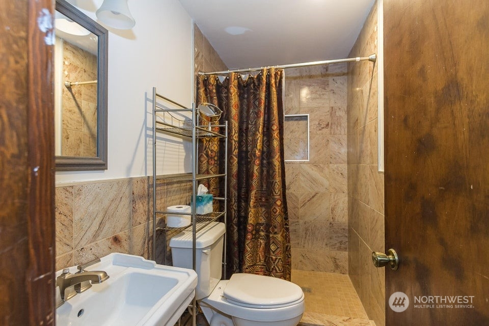 1144 State Rte 20 Colville, WA 99114 - Photo 25 of 38 a bathroom with a sink toilet and shower