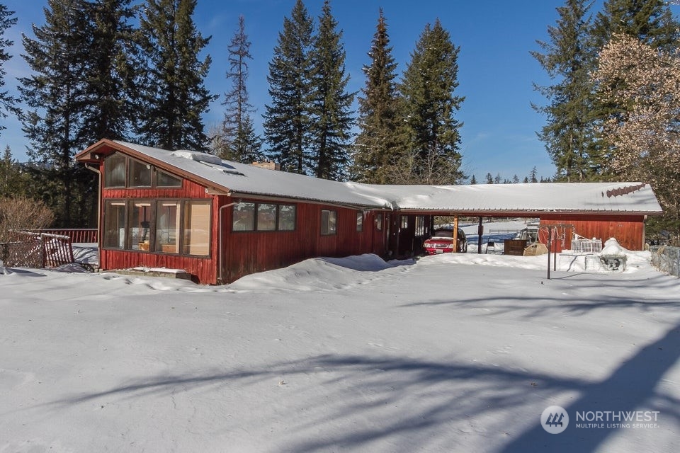 1144 State Rte 20 Colville, WA 99114 - Photo 3 of 38 a view of a house with a yard and large trees