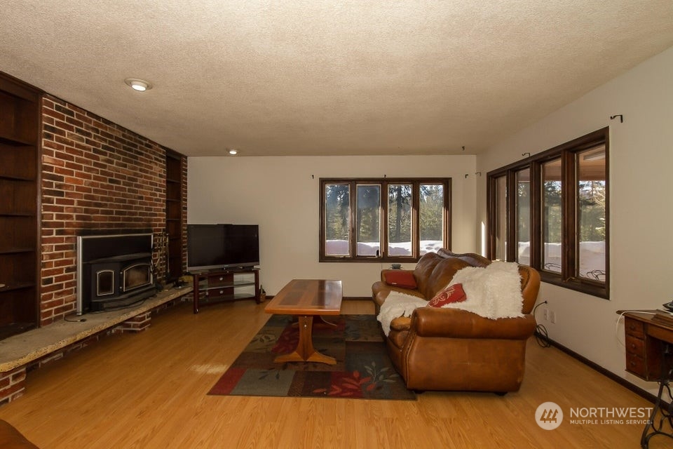 1144 State Rte 20 Colville, WA 99114 - Photo 6 of 38 a living room with furniture tv and a fireplace